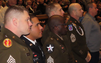 Veterans stand and are recognized at the high school's Veterans Day program
