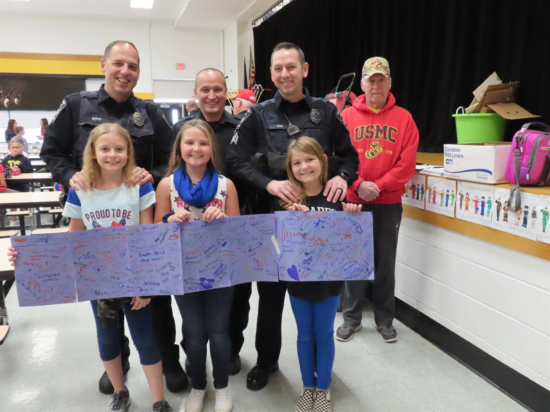 First responders with daughters and their thank you cards