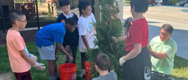 JHIS students planting trees on Earth Day