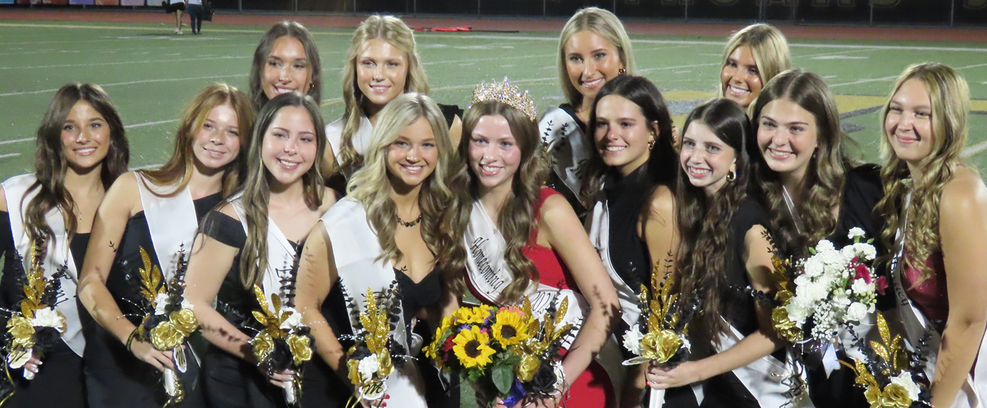 The 2024 Homecoming Court standing on the football field