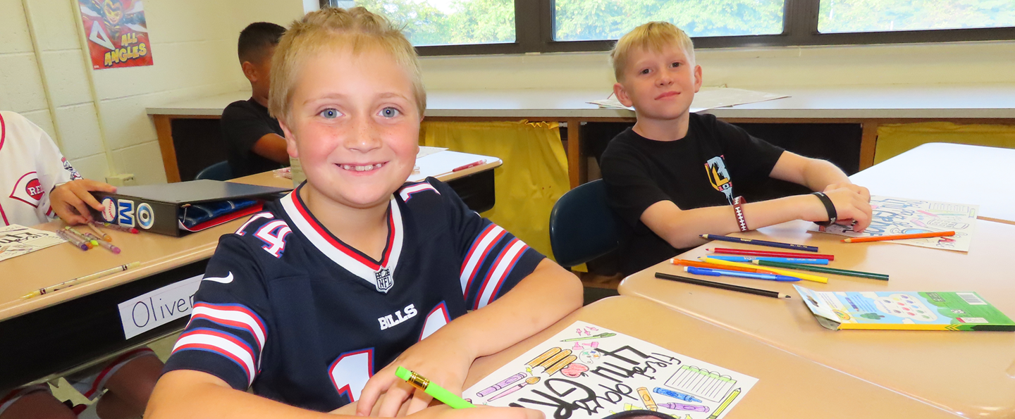 Students work at their desks on the first day of school