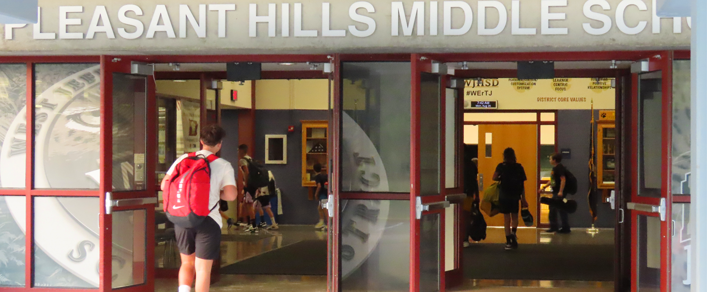 Students walk into Pleasant Hills Middle School on the first day of school